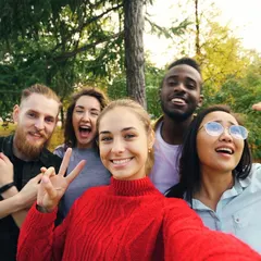 Four friends taking a selfie outdoors